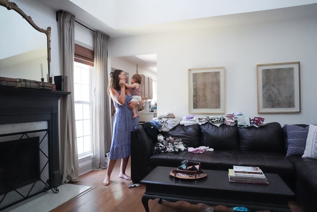 mother holding baby in a sunny room