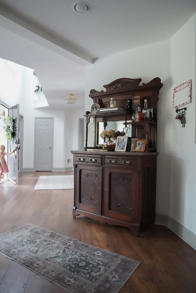 Antique dark wood bar with mirror backsplash and cabinets on bottom