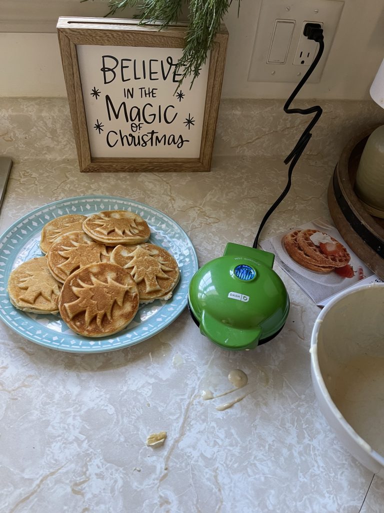 christmas tree pancakes on kitchen counter with christmas decor in background